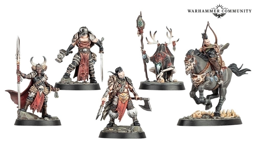 A collection of five Warhammer miniature figures, each showcasing unique warrior designs, weapons, and armor, positioned on individual bases. They are styled as low-fantasy tribal warriors and mystics